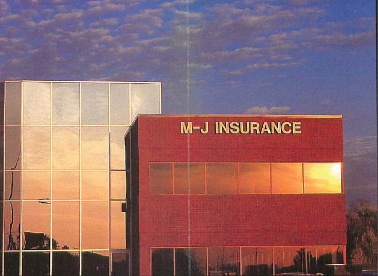 Historical image of MJ Insurance office building.