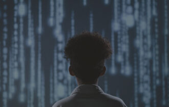 Woman looking up at cyber wall