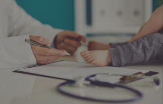 Male doctor with little child in medical clinic
