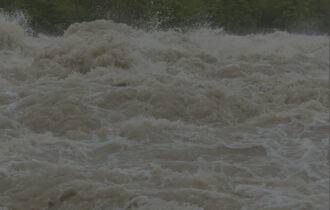 A big wave of brown water